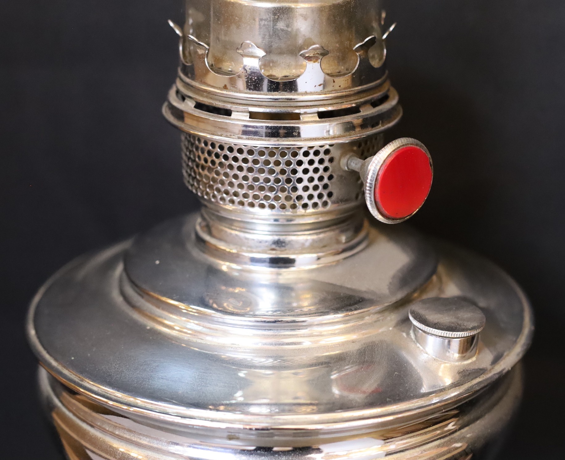 A 1930s nickel plated oil lamp with plain glass flue, height overall 68cm